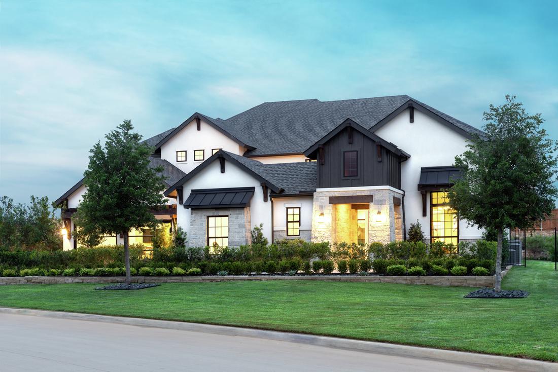 Exterior of home featuring modern farmhouse design, black awnings and white paint. 