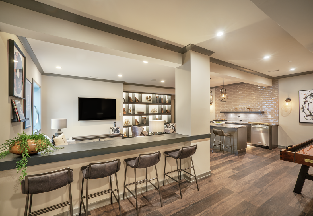Basement with bar, brown leather barstools and pool table