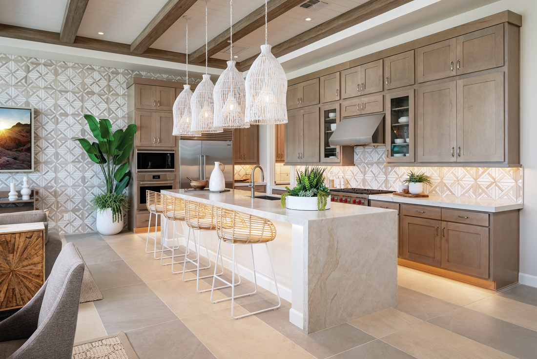 Kitchen with white pendants, brown cabinets, kitchen island, and wood-beamed ceiling